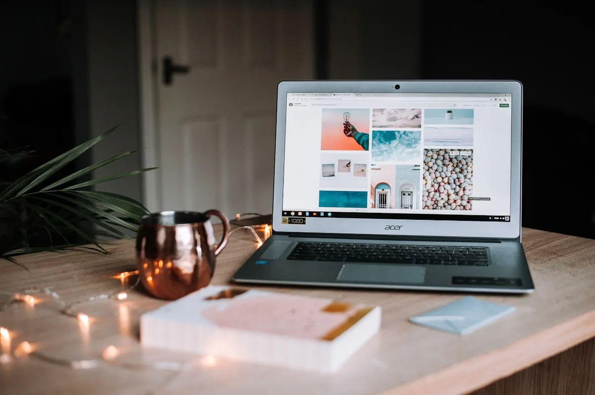 Laptop and coffee on a wooden café table